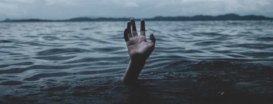 A hand reaching out of the water