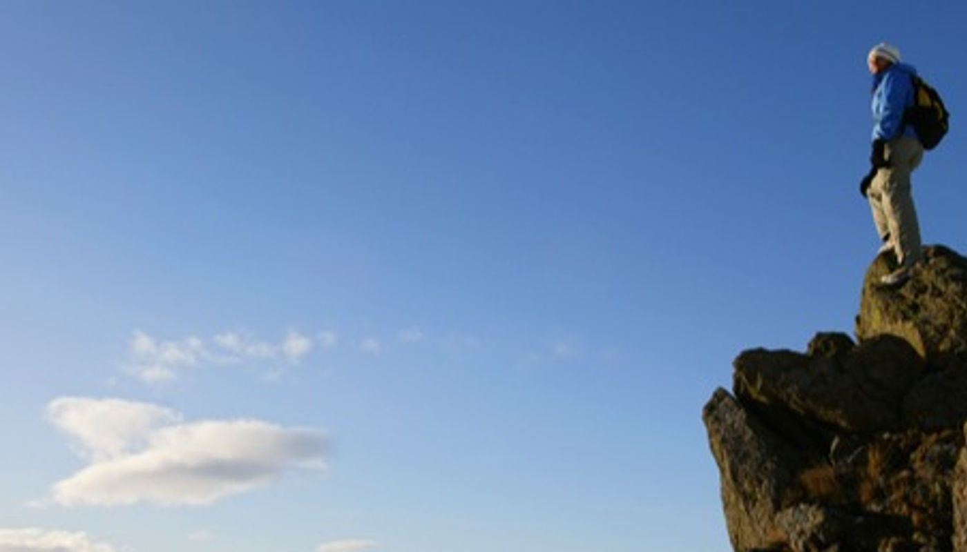 A climber atop a mountain