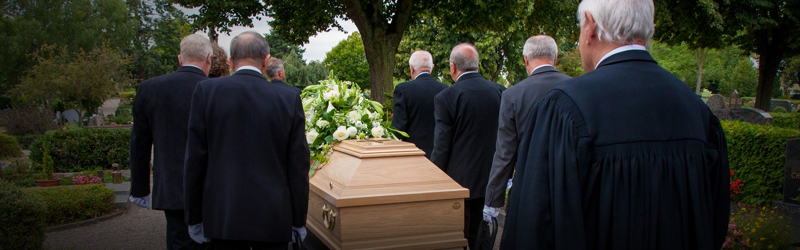 Pallbearers carrying a casket at a funeral